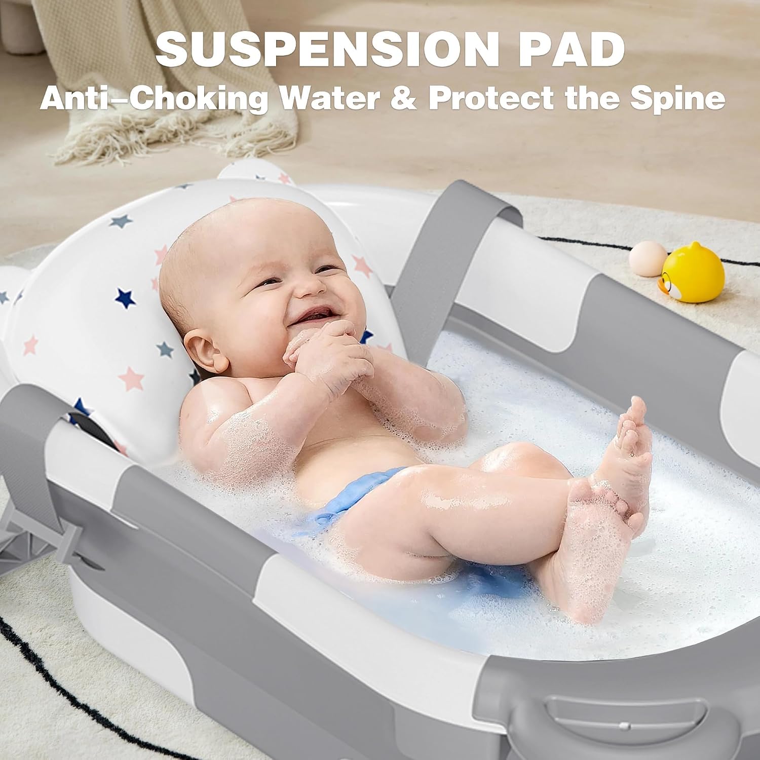 Baby reclined on the star cushion in the MoreFeel tub with soapy water